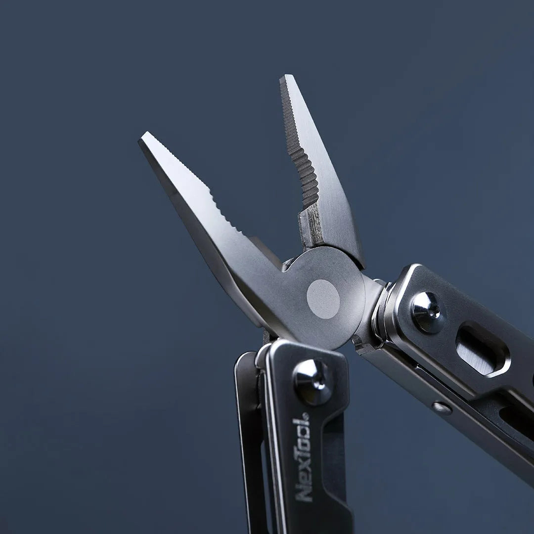 White stainless steel multi-function tool showing wrench, knife blade, and needle-nose pliers heads.
