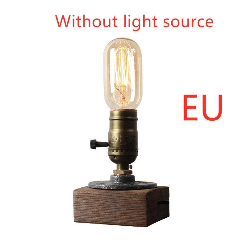 Small wooden and iron water pipe shaped table lamp on a table