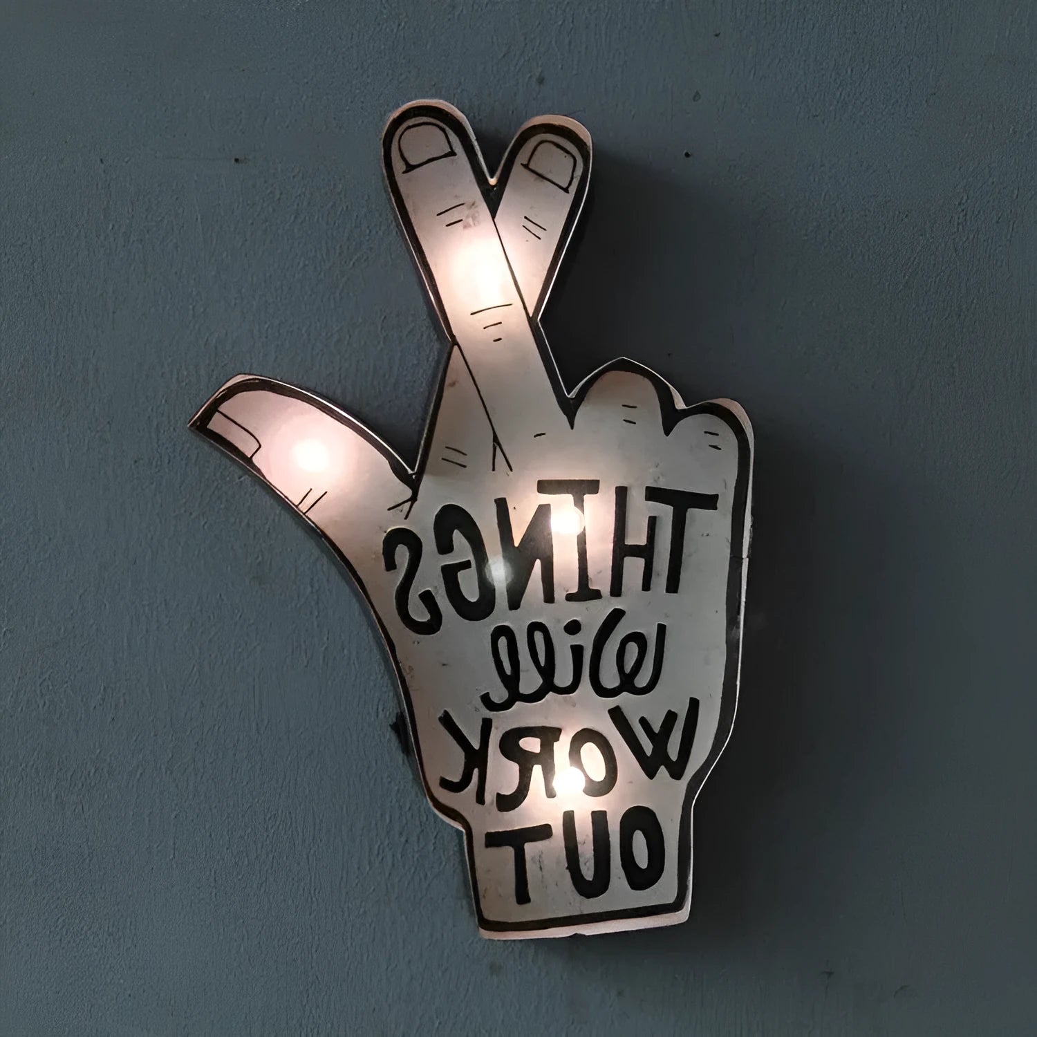 Shapeable vintage-style LED neon sign being bent to form a custom design on a wall.
