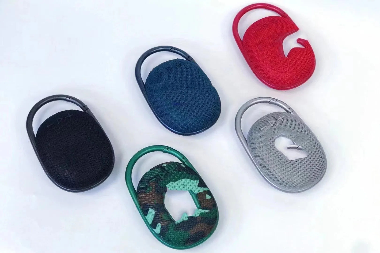 Mini portable Bluetooth speaker in multiple colours including pink, blue, black, red, silver grey, and green.