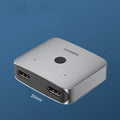 Grey Haibeisi HDMI switcher device with two input ports and one output port for 4K video switching.