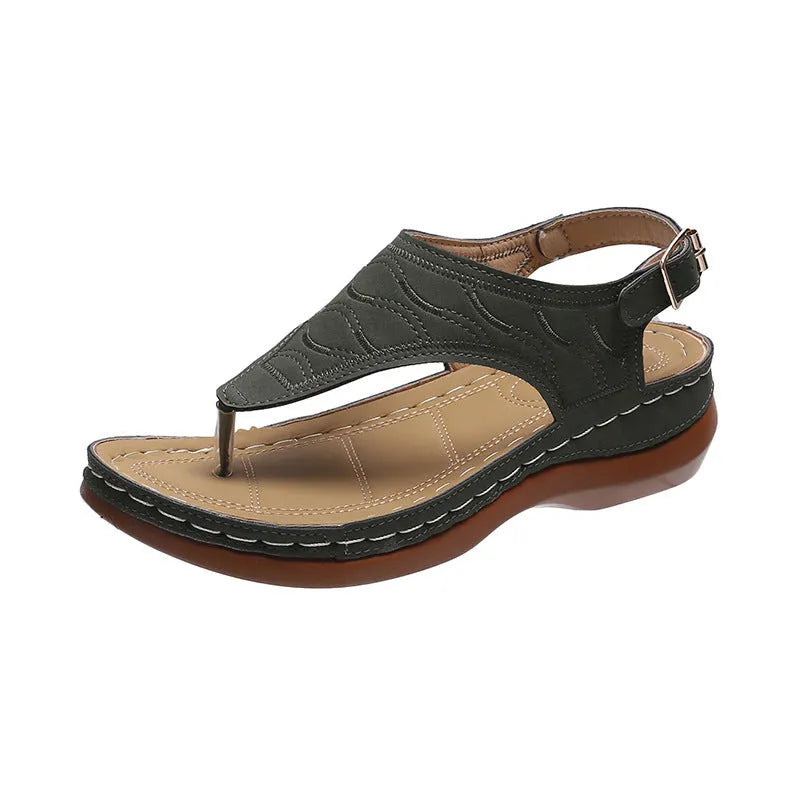 Women's wedge heel flip flop sandals with an adjustable buckle back strap in black.