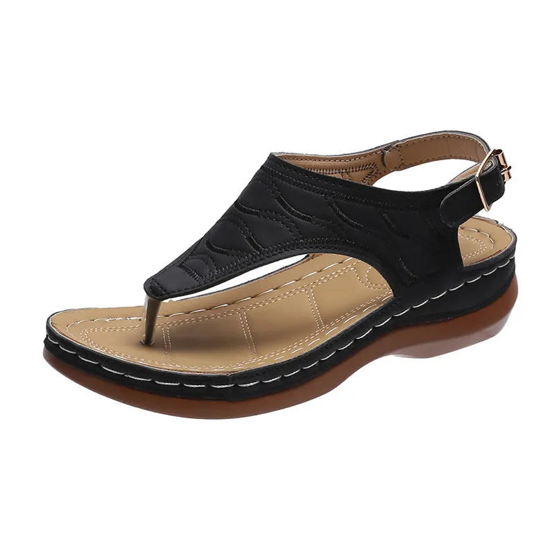 Women's wedge heel flip flop sandals with an adjustable buckle back strap in black.