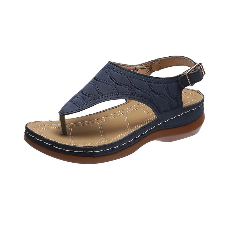 Women's wedge heel flip flop sandals with an adjustable buckle back strap in black.