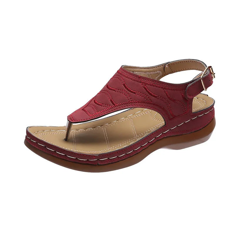 Women's wedge heel flip flop sandals with an adjustable buckle back strap in black.