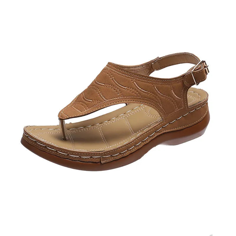 Women's wedge heel flip flop sandals with an adjustable buckle back strap in black.