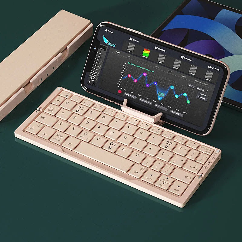 Aluminium folding Bluetooth keyboard open with smartphone on stand showing silver white finish