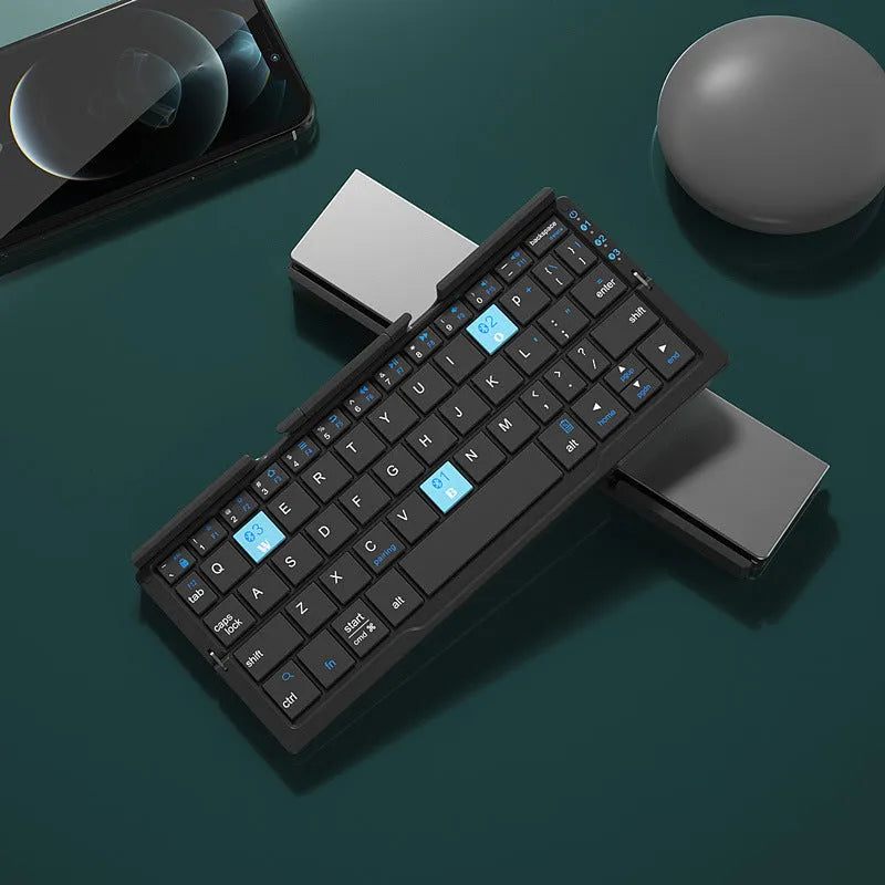 Aluminium folding Bluetooth keyboard open with smartphone on stand showing silver white finish