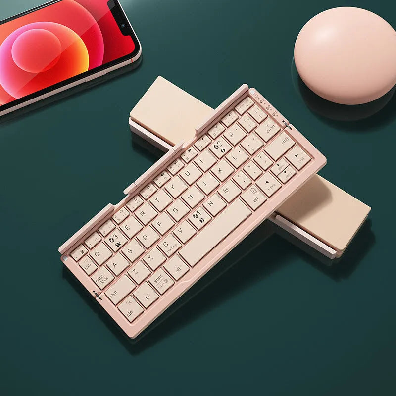 Aluminium folding Bluetooth keyboard open with smartphone on stand showing silver white finish