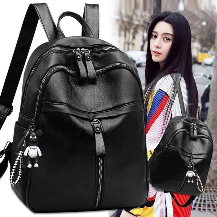 Black PU leather backpack with 20-35L capacity showing zipper opening and double straps
