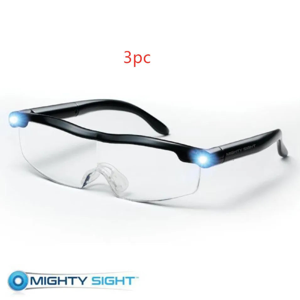 Transparent black USB LED reading glasses with integrated lighting, shown on reading material