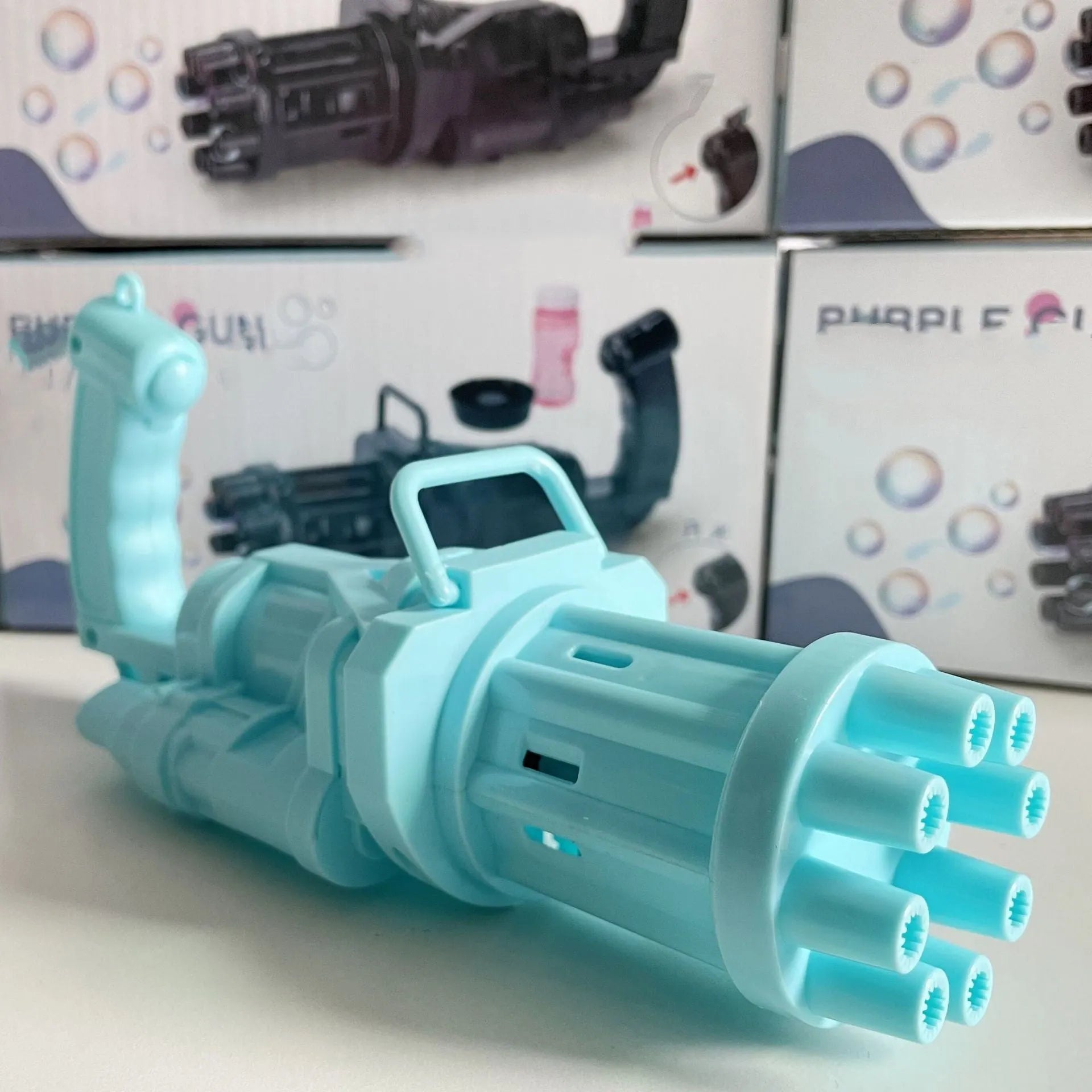 Child's plastic bubble blower gun in pink, gold, or black with removable bubble head for use as a fan.