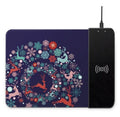 Black wireless charging mouse pad with RGB edge lighting and a white cartoon dot pattern on a desk.