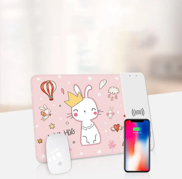 Black wireless charging mouse pad with RGB edge lighting and a white cartoon dot pattern on a desk.