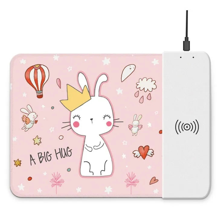 Black wireless charging mouse pad with RGB edge lighting and a white cartoon dot pattern on a desk.