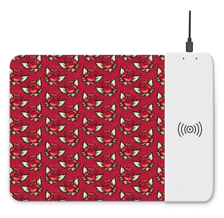 Black wireless charging mouse pad with RGB edge lighting and a white cartoon dot pattern on a desk.
