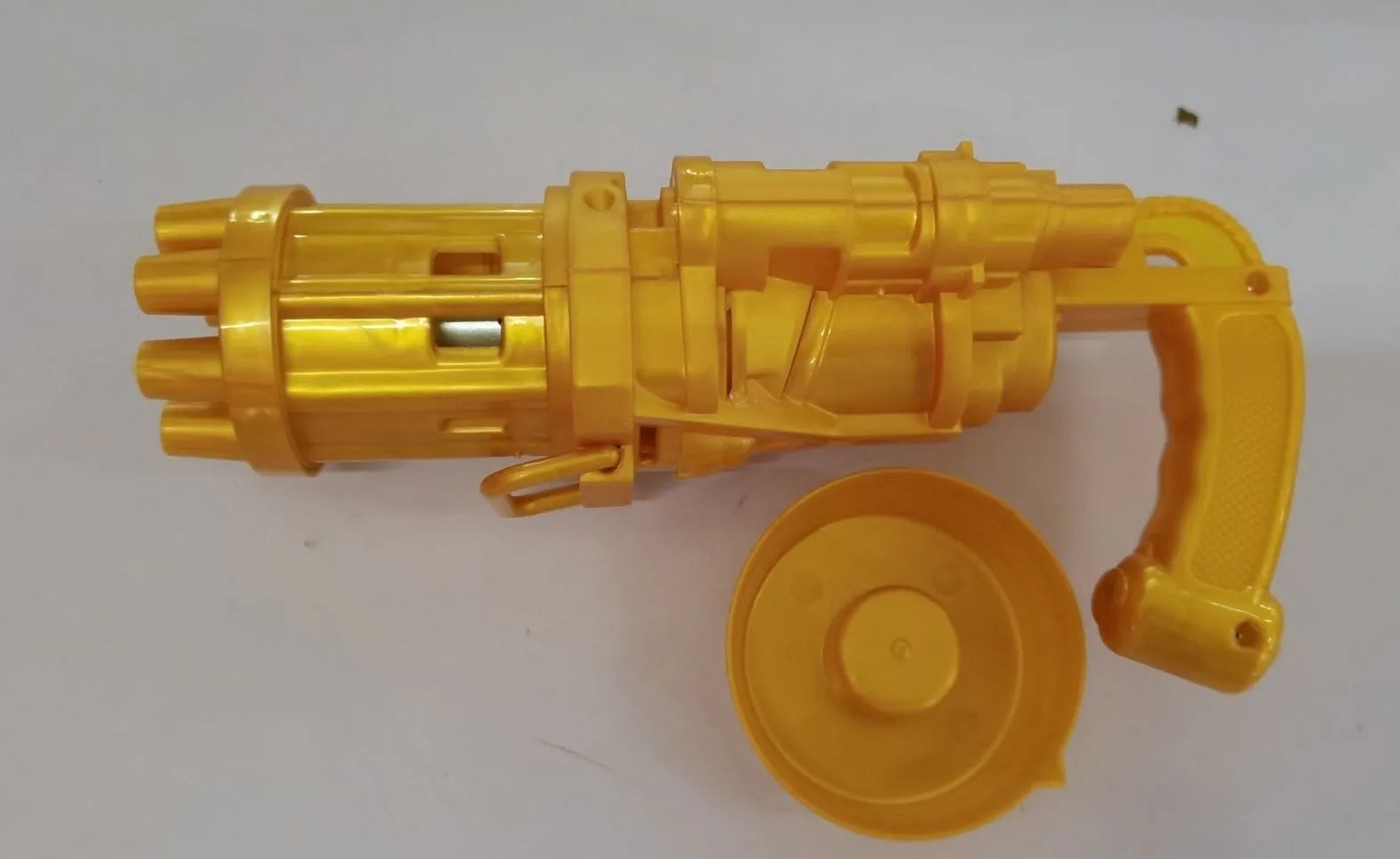 Child's plastic bubble blower gun in pink, gold, or black with removable bubble head for use as a fan.