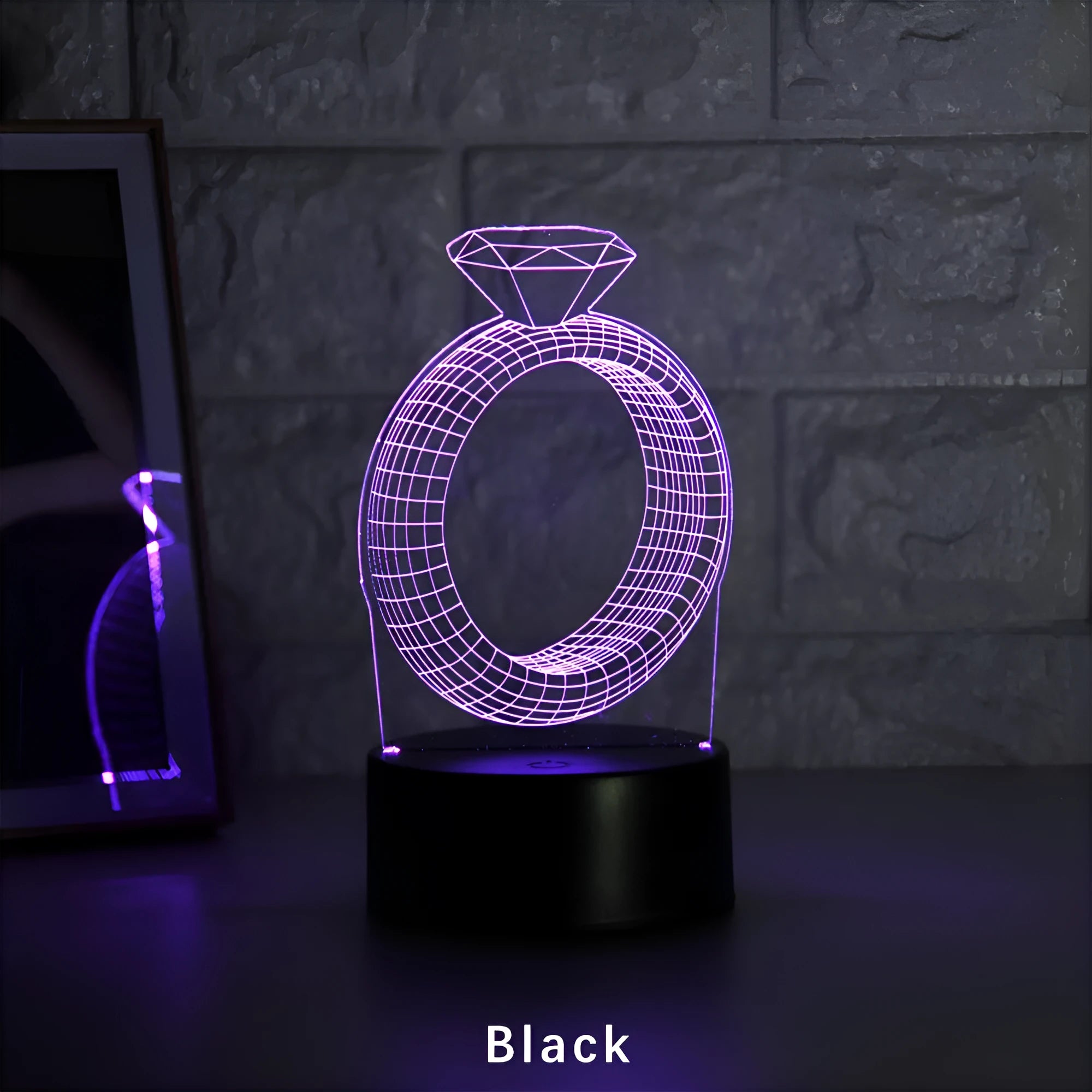 3D diamond ring LED night light with colour-changing illumination on a black base.