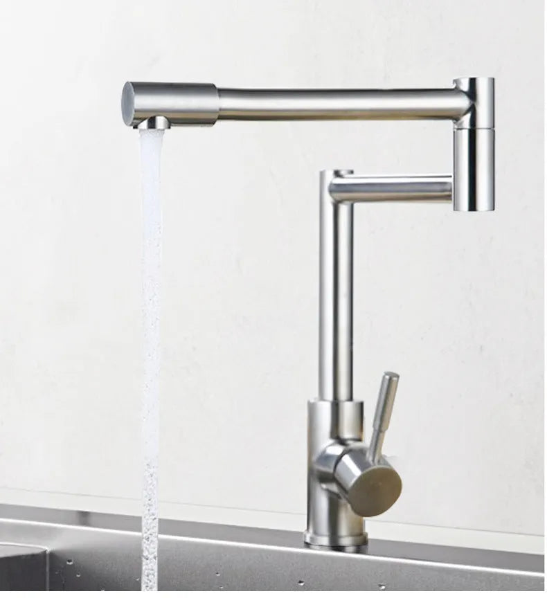 Silver stainless steel kitchen tap with two handles and rotating spout