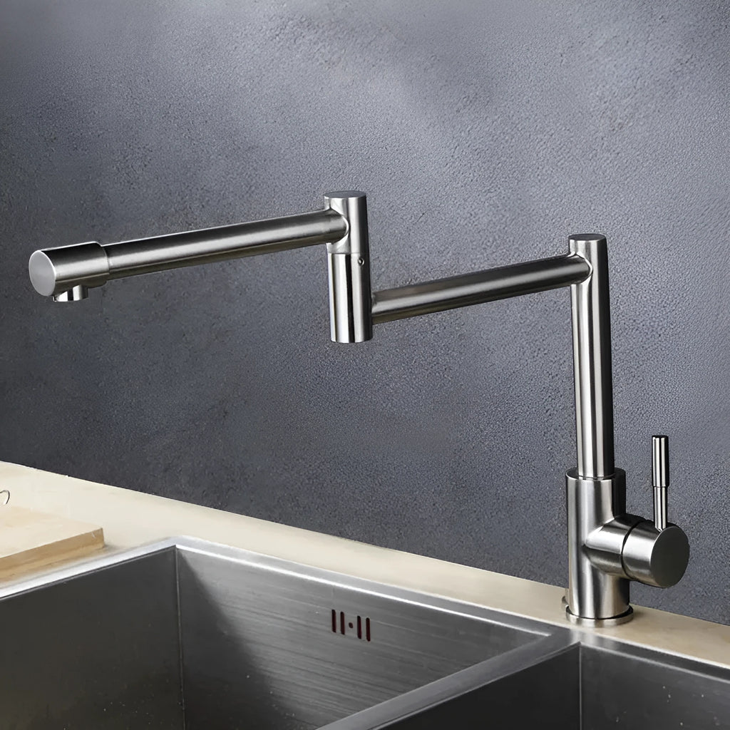 Silver stainless steel kitchen tap with two handles and rotating spout