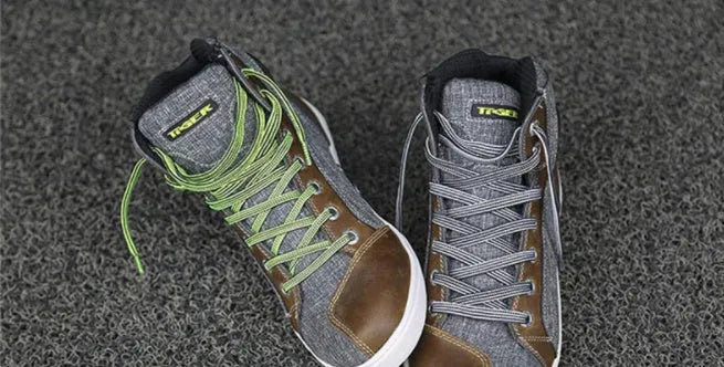 Black and grey motorcycle riding shoes showing short boot design with anti-fall sole pattern