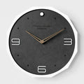Circular 12-inch Nordic style wall clock with perforated numerals in minimalist design