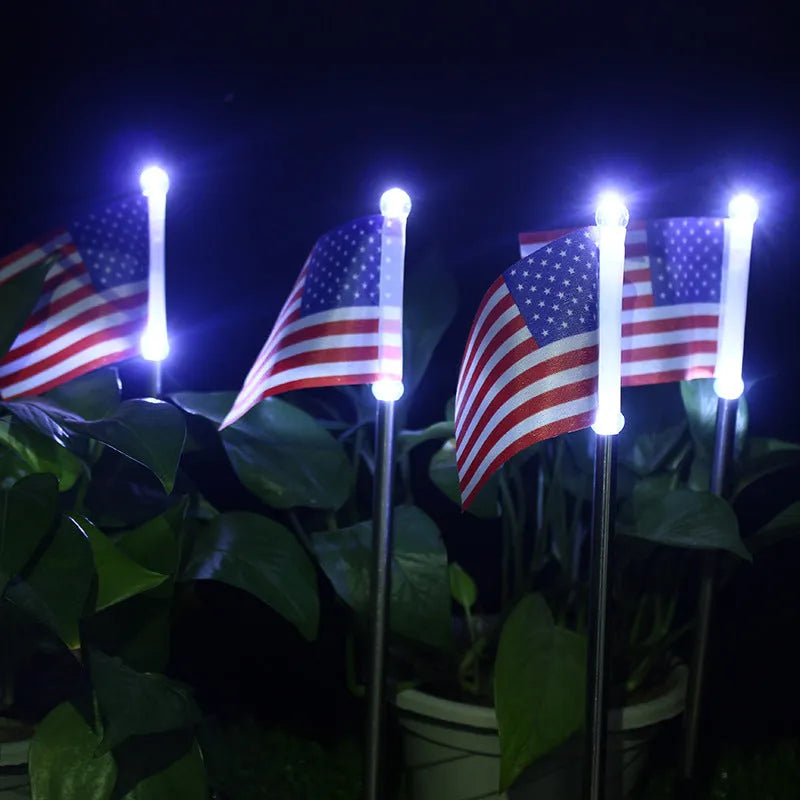 Solar garden flag light with stainless steel pole showing either American or British flag design.