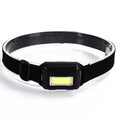 Black Mini COB LED headlight with adjustable polyester head strap, showing compact size.