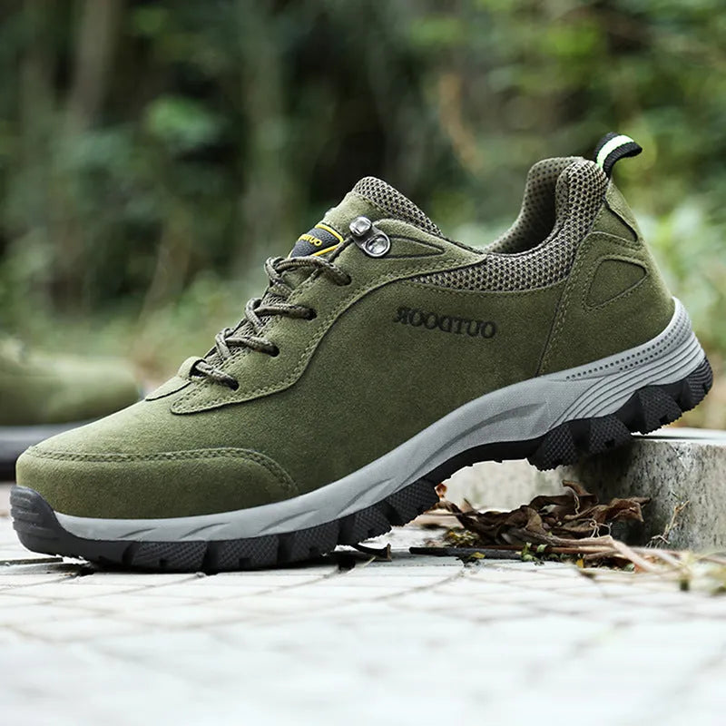 Men's army green low-top hiking shoes on a neutral background, showing the casual design and tread.
