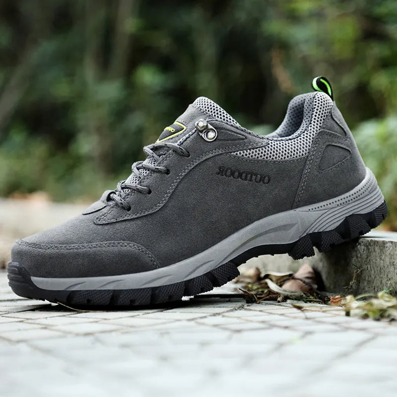 Men's army green low-top hiking shoes on a neutral background, showing the casual design and tread.