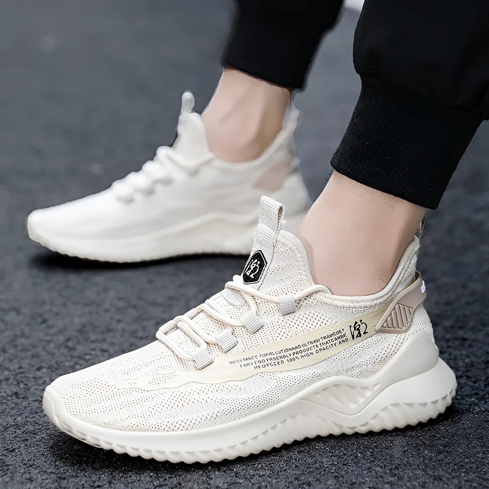 Men's low-top white mesh sports shoes with black rubber sole and lace-up front.