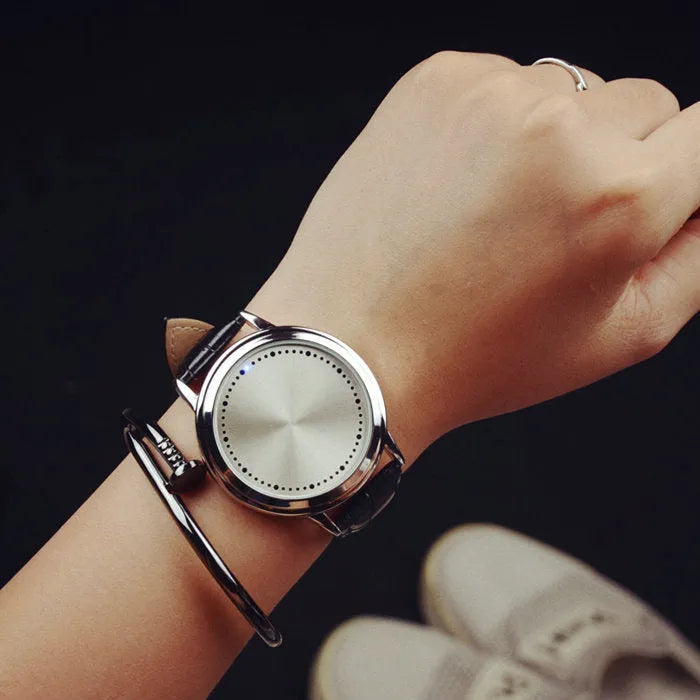 Electronic digital watch with blue LED display showing time numbers