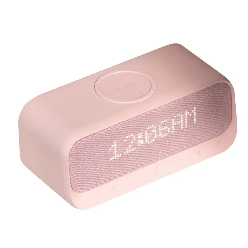 Soundcore white Bluetooth speaker with wireless charging pad and digital display showing alarm clock
