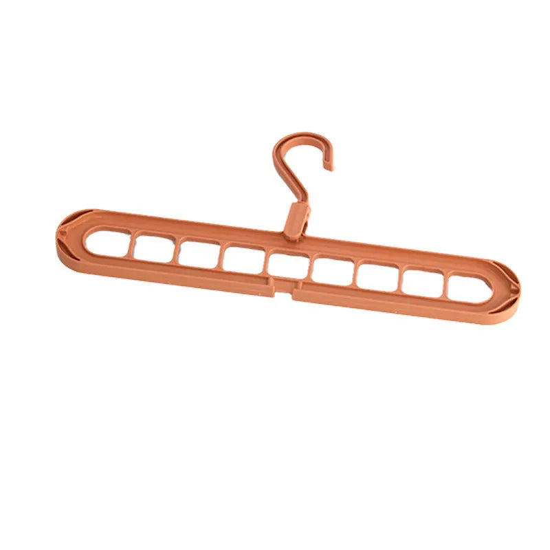 A green plastic multifunctional hanger with nine holes for trousers, shown in a folded and unfolded position.