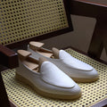 Men's brown genuine leather flat loafers with a low cut and TPR sole on a light background.