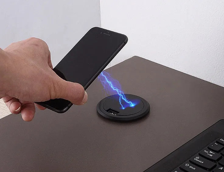 Round hidden wireless charger for embedding in desks, compatible with iPhone and Samsung phones.
