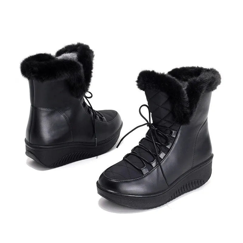 Black women's lace-up winter ankle boots with a platform sole on a white background