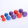 Set of bright red and blue plastic fitness dumbbells on a light floor.