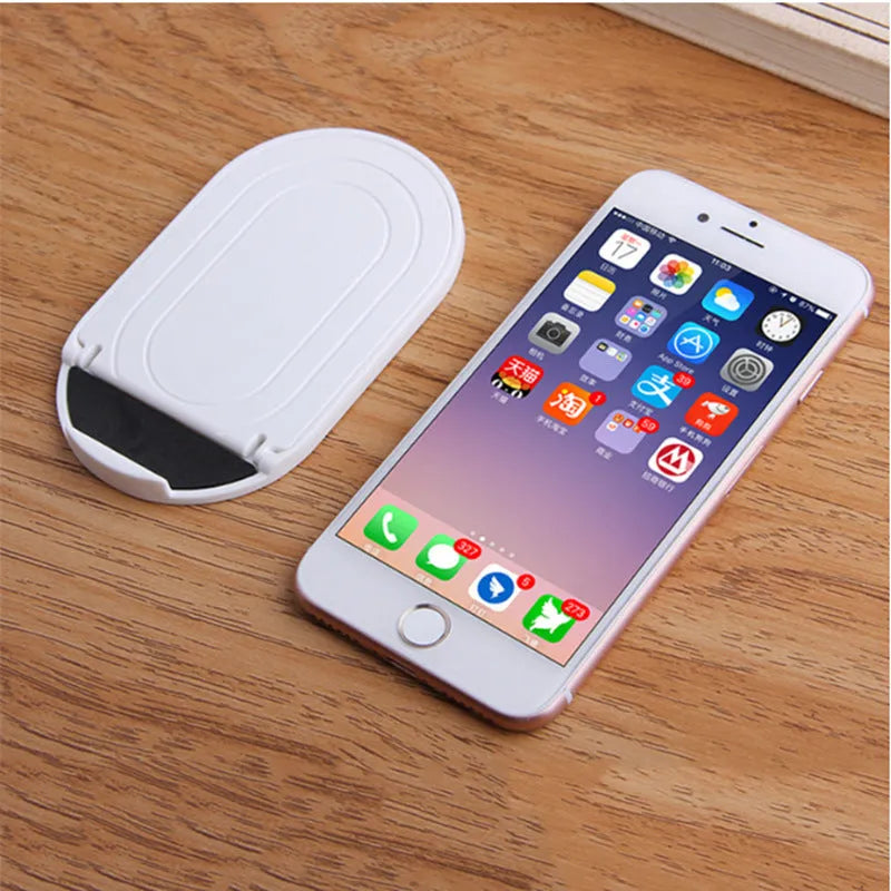 Adjustable plastic mobile phone stand in six colour options showing lazy bracket design