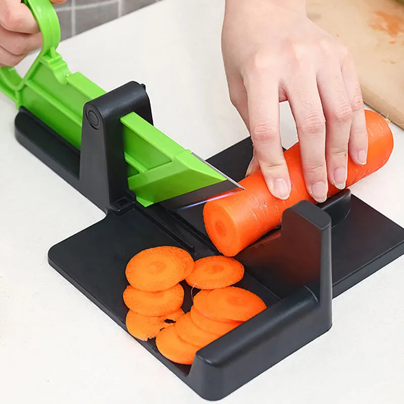 Green and red modern vegetable cutting tool for carrots and potatoes on a kitchen counter