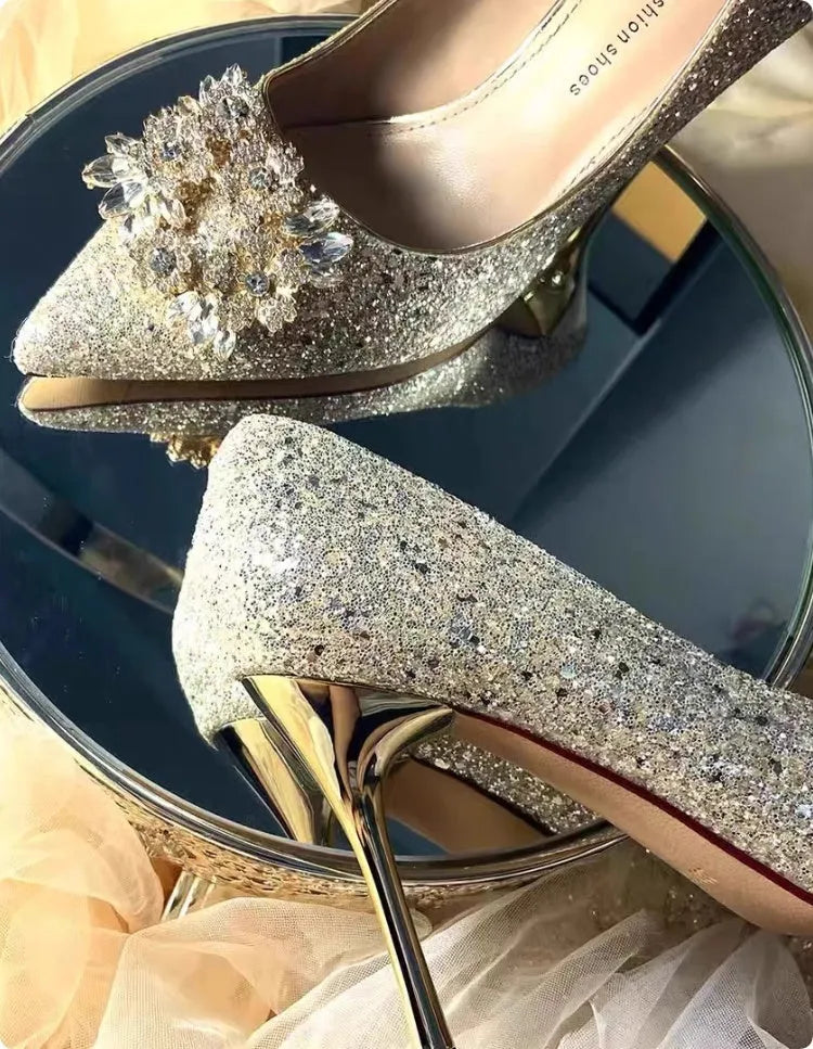 Champagne coloured bridal shoes with pointed toe, fine heel, and rhinestone floral decoration.
