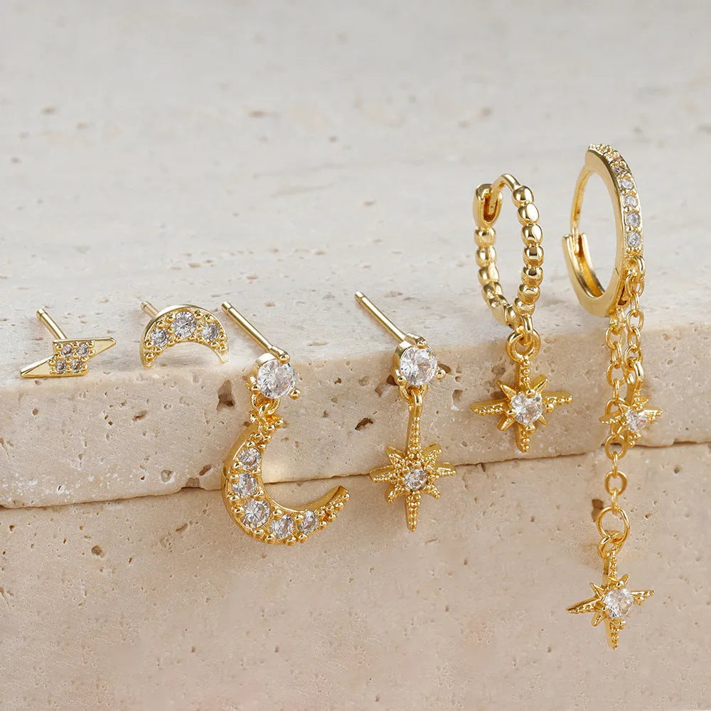Set of six gold-coloured women's earrings with chain tassel designs and zircon studs on a white background.
