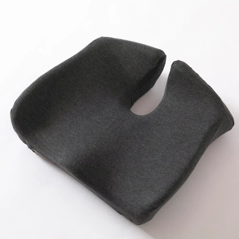 A solid grey memory foam office chair cushion for lumbar support.