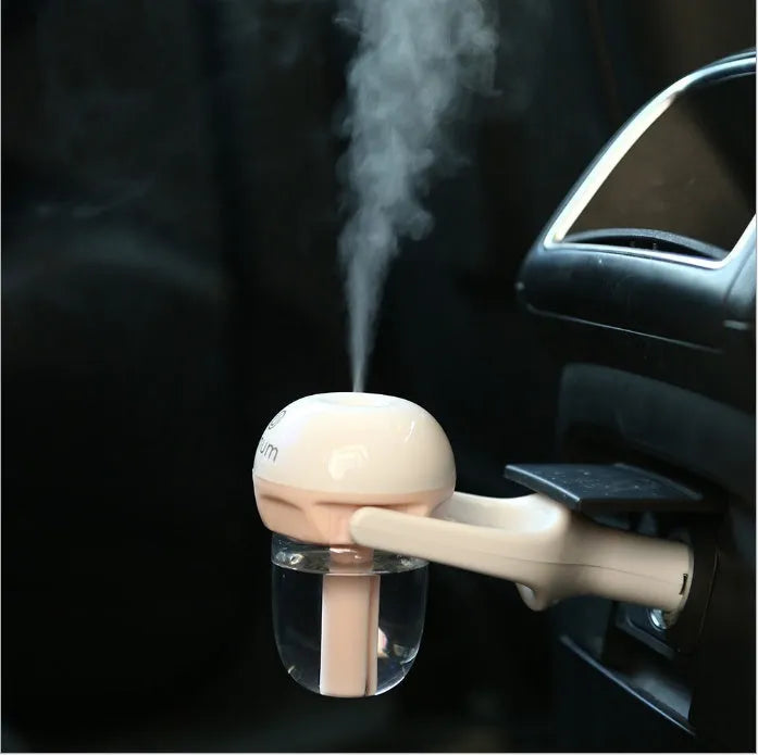 Compact blue car humidifier air purifier with essential oil diffuser function on car dashboard