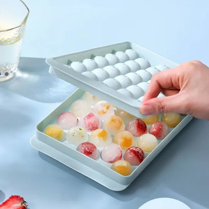 Blue silicone ice cube tray with lid showing 33 round compartments for homemade ice