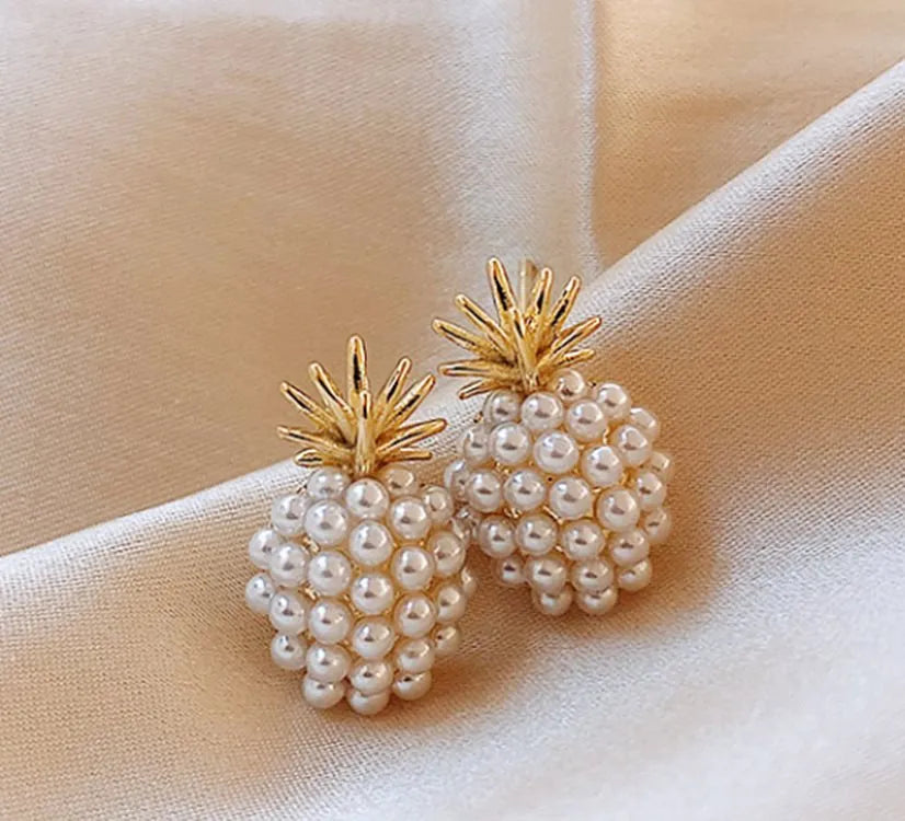 Korean style gold pineapple starfish pearl earrings made from electroplated alloy with inlaid stones.
