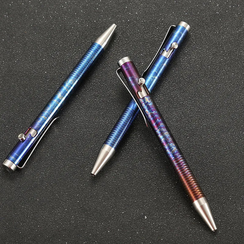 Titanium alloy ballpoint pen with gun bolt handle mechanism showing phantom colour finish variations