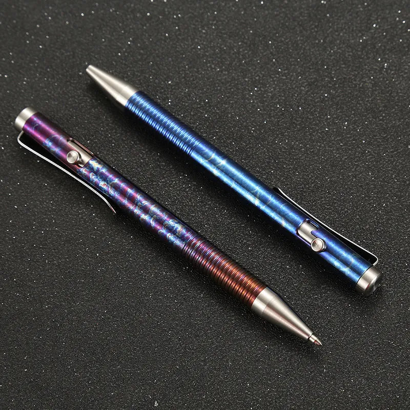 Titanium alloy ballpoint pen with gun bolt handle mechanism showing phantom colour finish variations