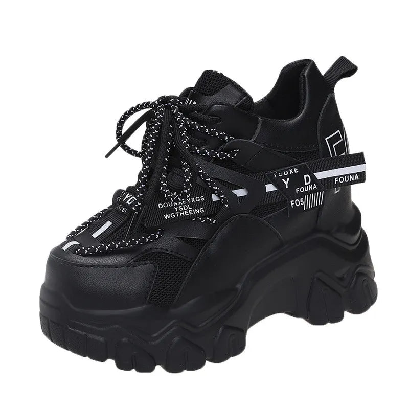 White and black women's mesh platform sports shoes with cross-strap and rubber sole.
