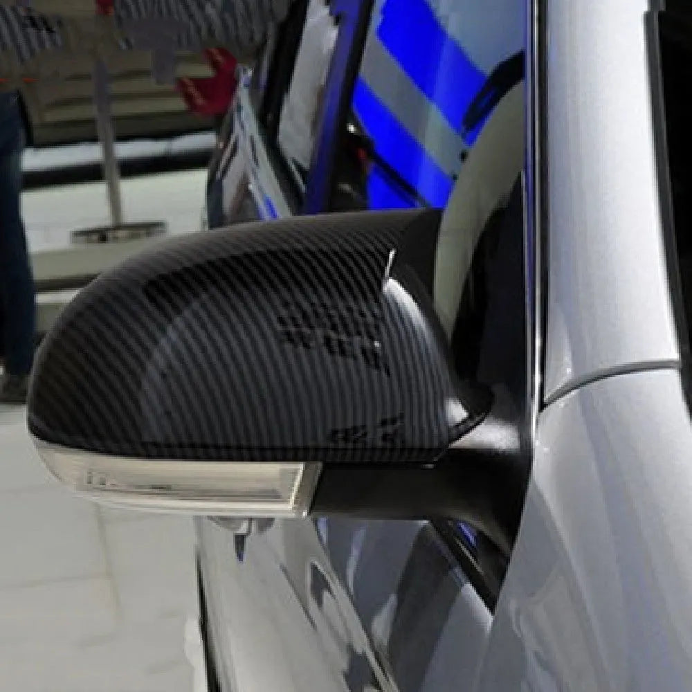 Volkswagen Sagitar exterior mirror housing shells in horn bright black plastic, pair shown